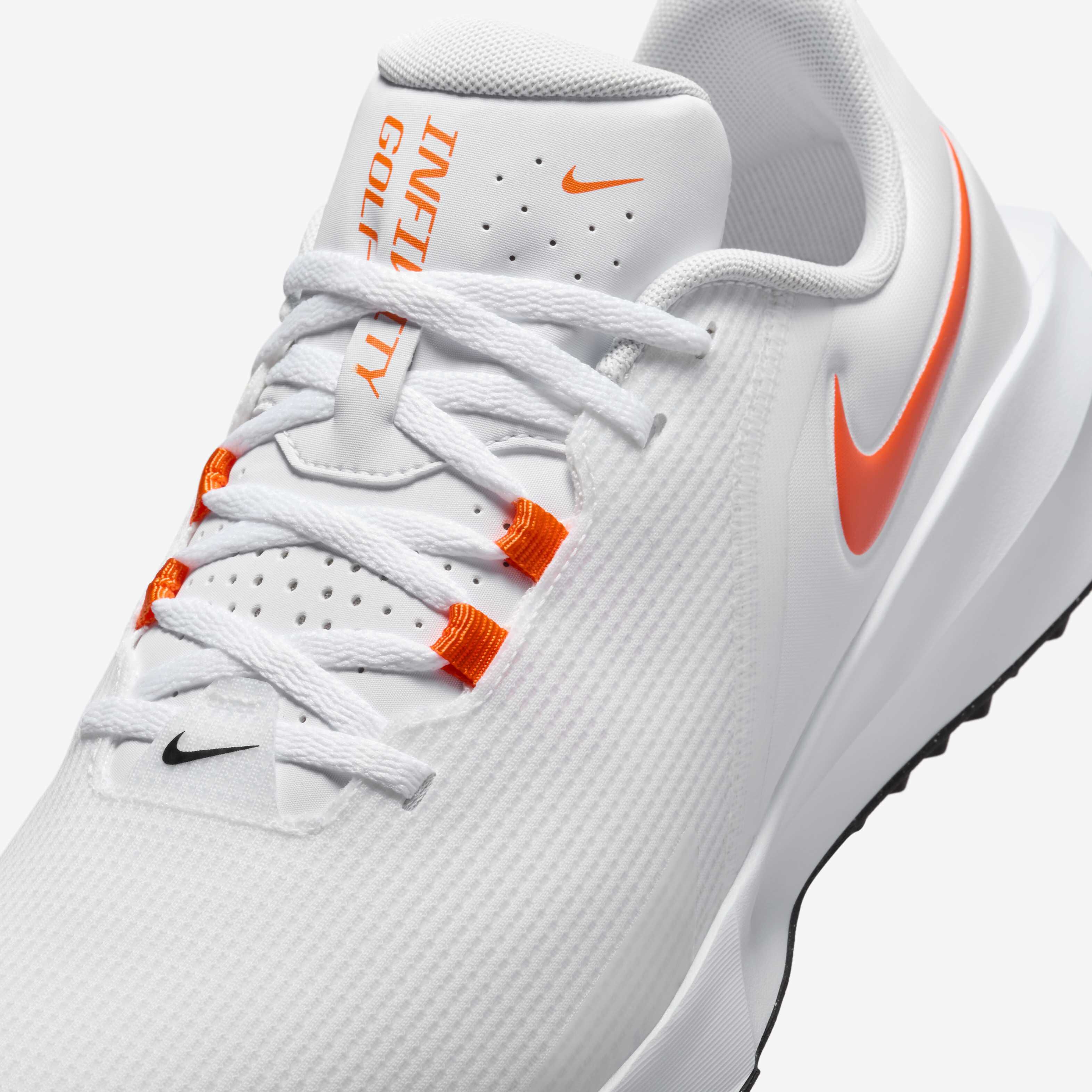 orange and white nike golf shoes